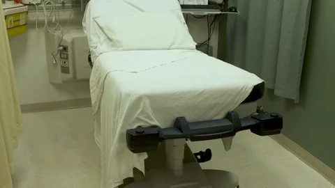 An empty hospital bed with monitors, clean and ready for a new patient. Stock Footage 119924544