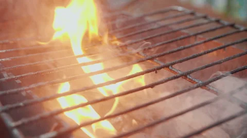 Empty hot barbecue grill with a flame of fire and smoke is burning, slow motion Stock Footage 157369987