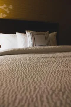 Empty hotel bed perspective view Stock Photos