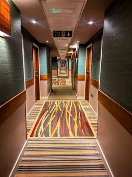 An Empty Hotel Corridor That Is Usually Found Busy With Customers Staying T.. Stock Photos