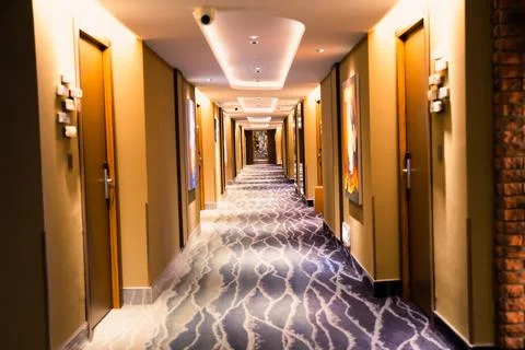Empty hotel corridor view at night with lights Stock Photos