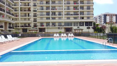 Empty hotel pool under open sky. White sunbeds without tourists, vacationers. Stock Footage 132485249