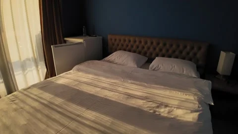 Empty hotel room interior with sunlight shining through window Stock Footage 345352928