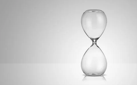Empty hourglass on gray background Фото