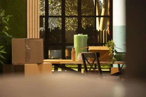 Empty house room filled with moving boxes and wrapped belongings Stock Photos