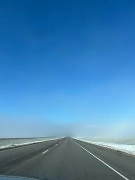 Empty I-15 highway through snowy foggy landscape in Utah, USA Stock Photos