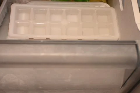 Empty ice cube tray in a freezer Stock Photos