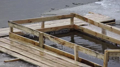 Empty Ice hole for bathing fenced with wooden planks, feast of Epiphany in Stock Footage 295106352