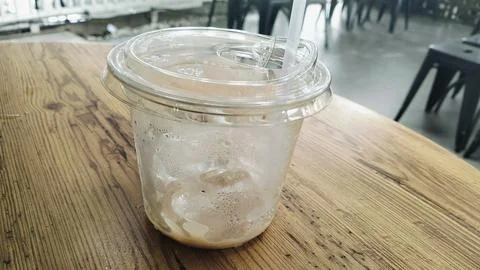 Empty Iced Coffee Takeaway Plastic Cups with Leftover Ice Cubes Stock Photos