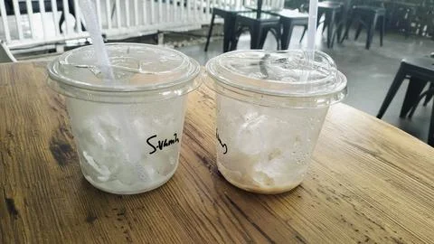 Empty Iced Coffee Takeaway Plastic Cups with Leftover Ice Cubes Stock Photos
