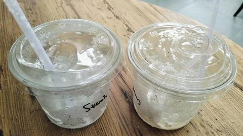Empty Iced Coffee Takeaway Plastic Cups with Leftover Ice Cubes Stock Photos