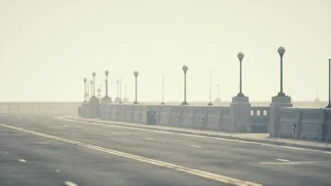 An empty illuminated asphalt road in a thick fog Illustrazione stock