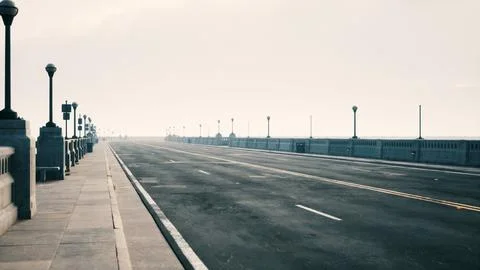 An empty illuminated asphalt road in a thick fog Illustrazione stock