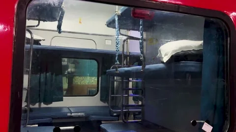 Empty indian railway 3ac sleeper train compartment with blue berths and ladder Stock Footage 329611474