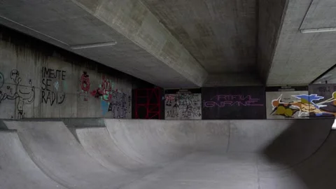 Empty indoor skate park with graffiti on the walls Stock Footage 226834350