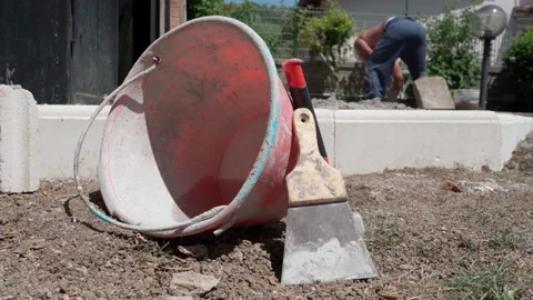 Empty industrial bucket lying down on the ground after cement mixing Stock Footage 162763157