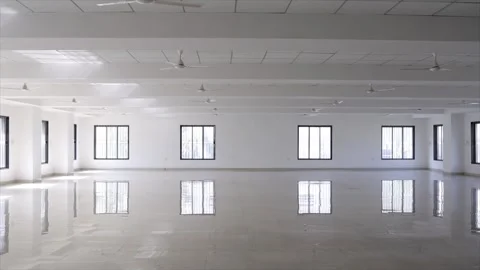 Empty Industrial Hall with Polished White Floor Windows and Ceiling Fans Stock Footage 332143731