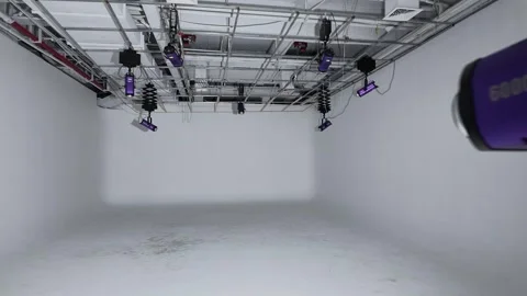 Empty Industrial Studio Room with Purple Spotlights Hanging from Ceiling Grid 库存影片 340471932