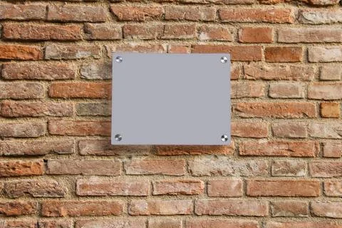 Empty information sign on old brick wall. Grey color Stock Photos