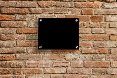 Empty information sign on old brick wall. Black color Stock Photos