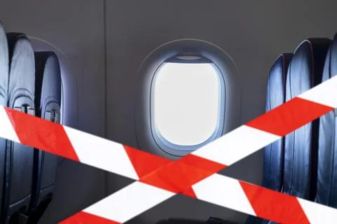 Empty interior of an airplane and red tape means do not sitting here Foto stock