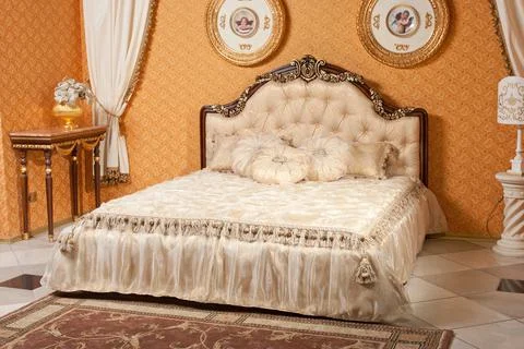 Empty interior bedroom background in warm colors decorated with classic luxur Stock Photos