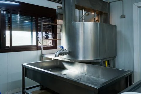 Empty interior of cheese making dairy plant with aluminium shelves and furniture Photos