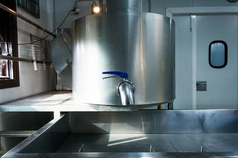 Empty interior of cheese making dairy plant with aluminium shelves and furniture 库存照片