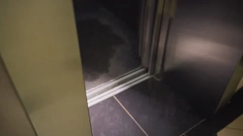 Empty Interior of Modern Elevator with Shiny Metal Walls and Floor Tiles Stock Footage 306497448