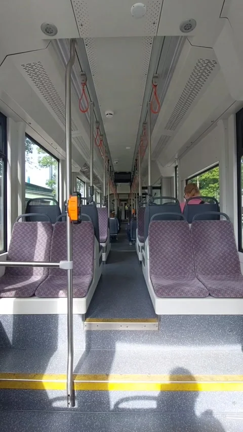 Empty interior of a modern moving public transport tram Stock Footage 342975107