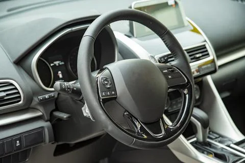 Empty interior of modern premium car dark interior close-up steering wheel and Stock Photos