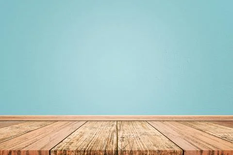 Empty interior room with light blue cement wall texture and brown wooden floo Stock Photos
