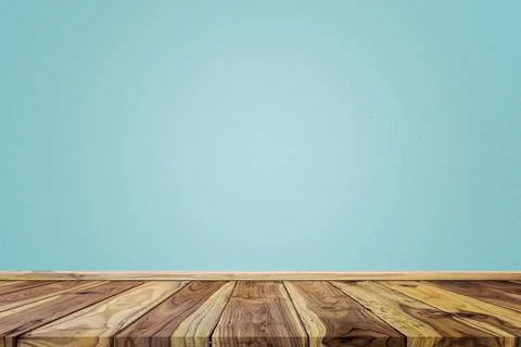 Empty interior room with light blue cement wall texture and brown wooden floo Stock Photos