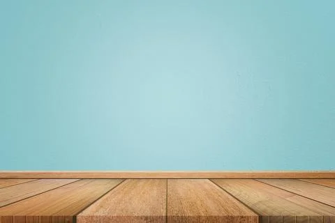 Empty interior room with light blue cement wall texture and brown wooden floo Stock Photos