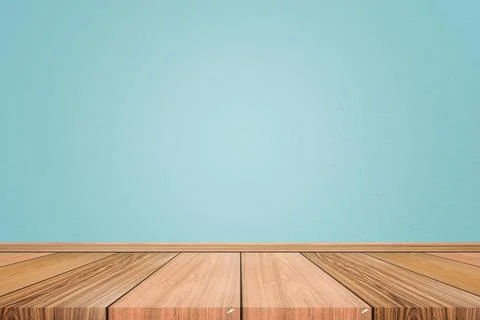 Empty interior room with light blue cement wall texture and brown wooden floo Stock Photos