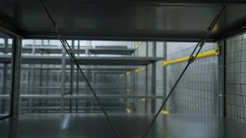 Empty iron shelves in warehouse. Creative. Packaged empty shelves in modern Stock Footage 178553678