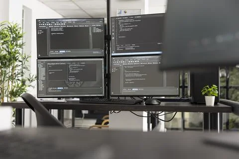 Empty IT office with computers and code displays Photos
