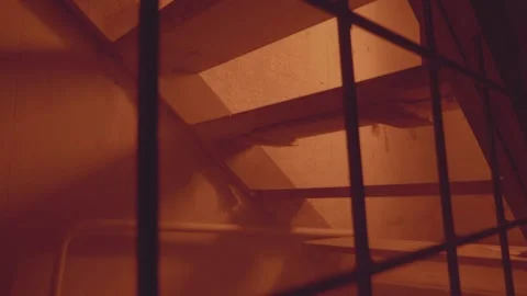 Empty jail cell. Prison. Horror or halloween concept. Orange electric light Stock Footage 238468296