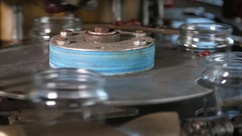 Empty jars for tomato rolling on a metallic device in tomato processing factory Stock Footage 118423247