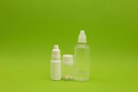 Empty jars, tubes, bottles on a green background Stock Photos