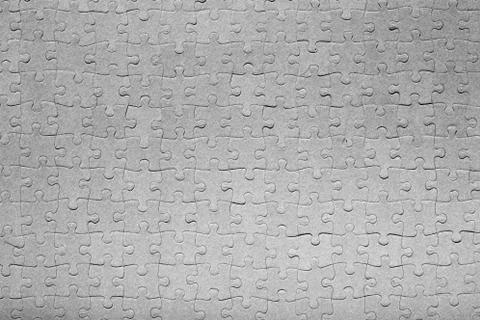 Empty jigsaw puzzle pattern in grey color Stock Photos