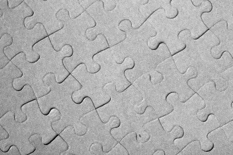 Empty jigsaw puzzle pattern in grey color Stock Photos