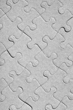 Empty jigsaw puzzle pattern in grey color Stock Photos