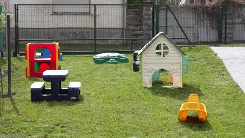 Empty kindergarten playground waiting for children on a sunny day in the Stock Footage 339404665