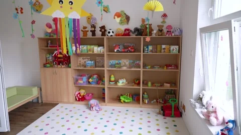 Empty kindergarten playroom with shelves full of toys and decorations Stock Footage 338444022