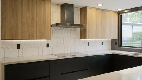 Empty kitchen after renovation with upper wooden cabinets and lover black Stock Footage 282256507