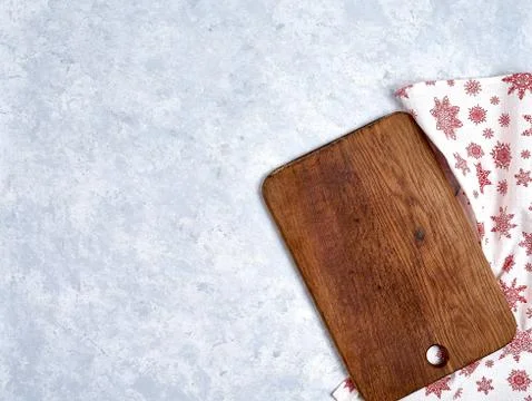 Empty kitchen cutting board with red christmas tablecloth. View from top. Stock Photos