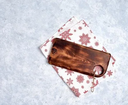 Empty kitchen cutting board with red christmas tablecloth. View from top. Stock Photos