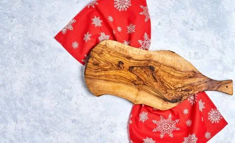 Empty kitchen cutting board with red christmas tablecloth. View from top. Stock Photos