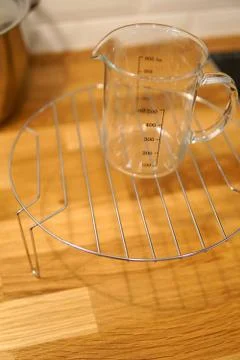 Empty kitchen measuring cup beaker isolated on blurred background Stock Photos